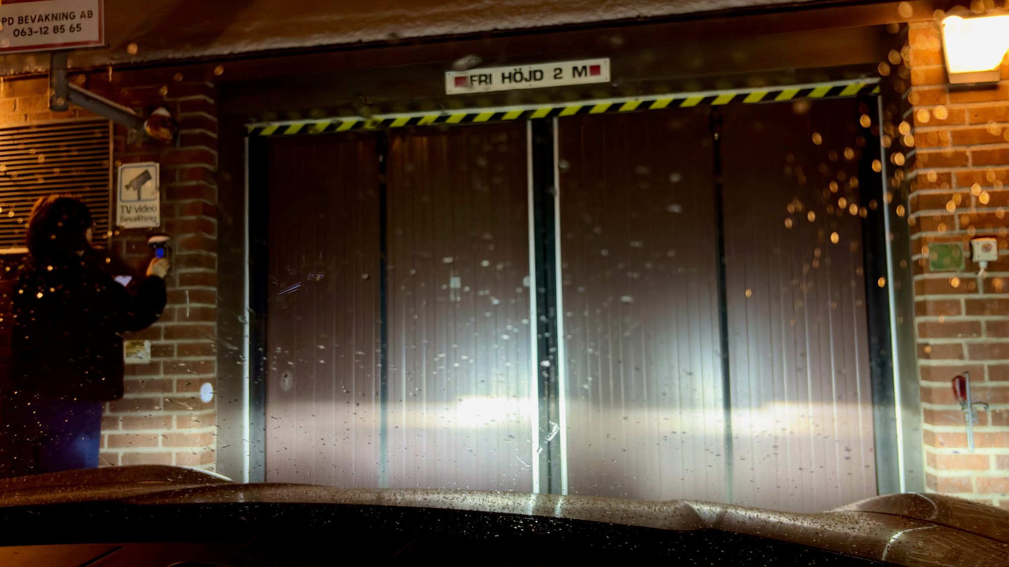 My co-driver typing in the code to our parking garage for tonight