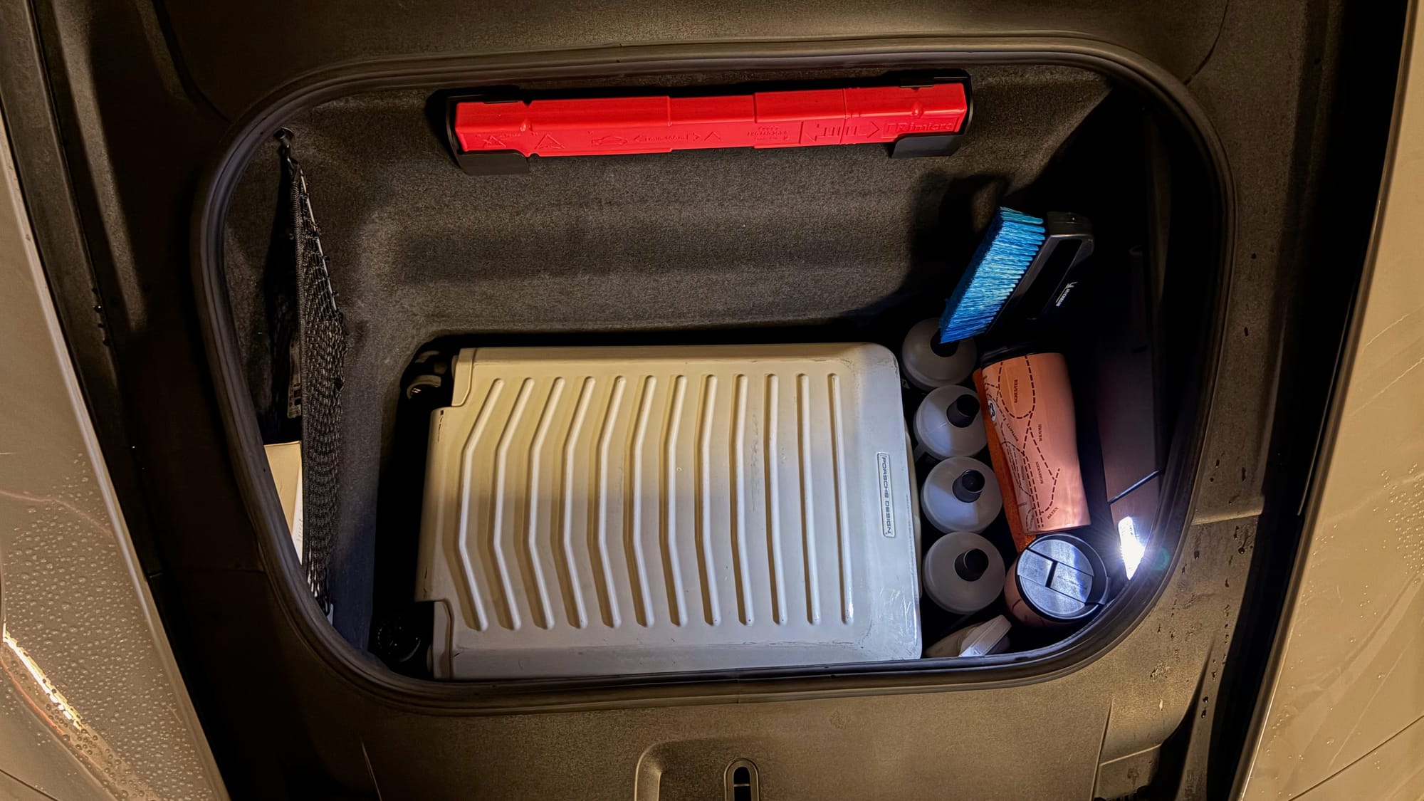 Half filled frunk with luggage and car preparation equipment