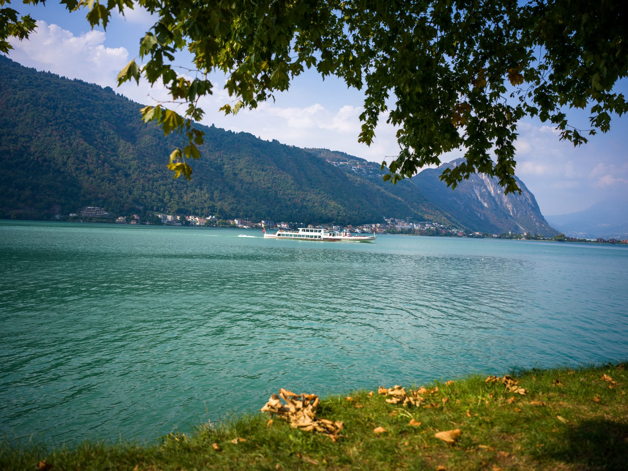Boats pass by on Lake Lugano